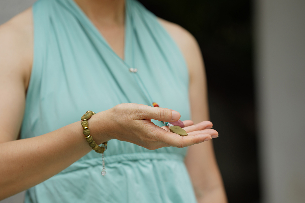 Zcheer wearable incense spiritual jewelry placed with natural incense materials in soft morning light before leaving home.