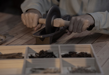 Grinding raw incense materials.