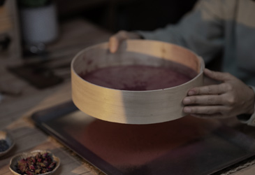 Sifting incense powder.