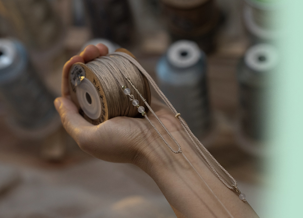 Handcrafted necklace and spool detail.