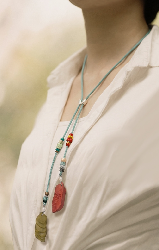 Model wearing symbolic necklace.